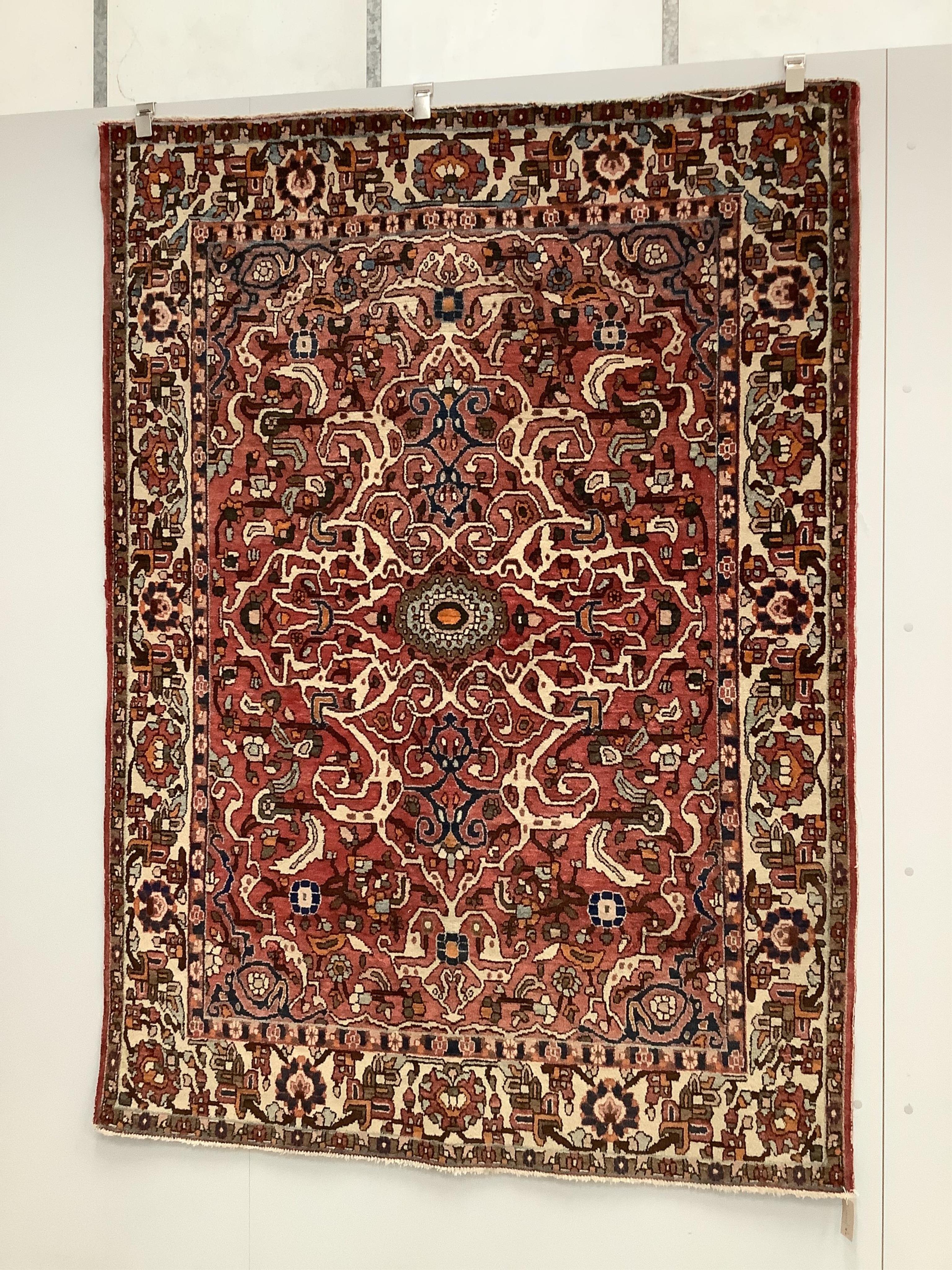 A North West Persian brick red ground rug, 200 x 148cm. Condition - fair